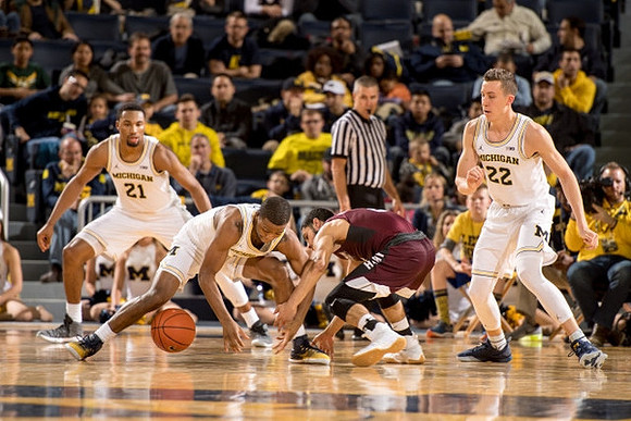 Zak Irvin (21), Xavier Simpson (3), and Duncan Robinson (22)