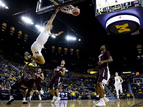D.J. Wilson (5) and Mark Donnal (34)