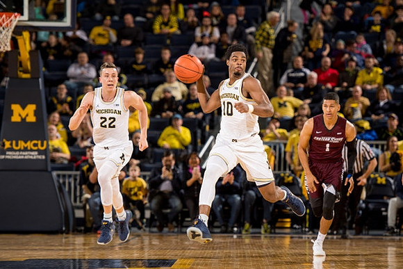 Duncan Robinson (22) and Derrick Walton Jr. (10)