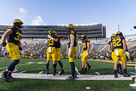 Erick All (83) and Michigan Team