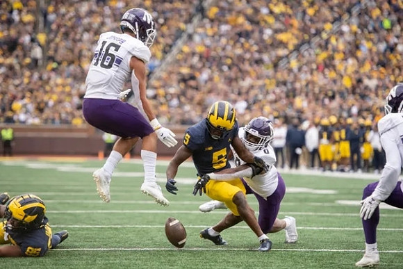Daylen Baldwin (85) and Mike Sainristil (5)