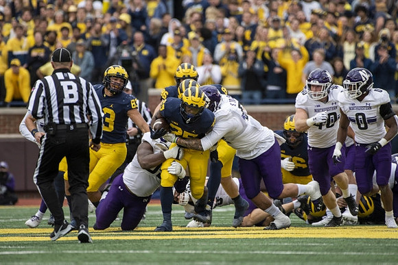 Erick All (83), Hassan Haskins (25), Luke Schoonmaker (86), and Ryan Hayes (76)