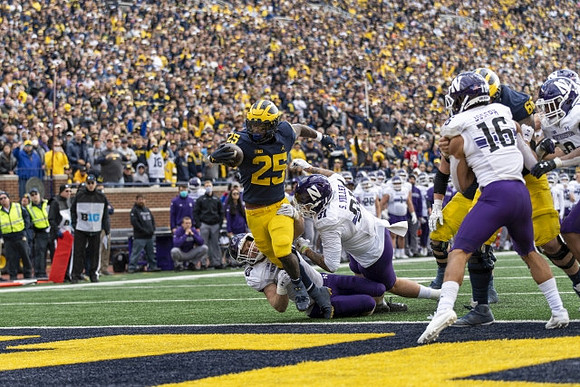 Hassan Haskins (25) and Chuck Filiaga (66)