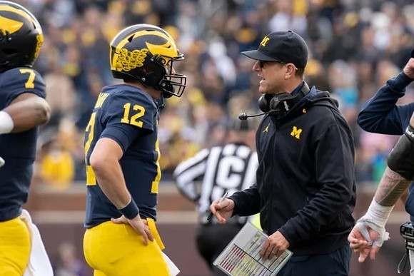 Donovan Edwards (7), Cade McNamara (12), and Jim Harbaugh