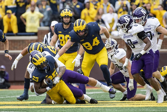 Hassan Haskins (25), Erick All (83), and Joel Honigford (84)