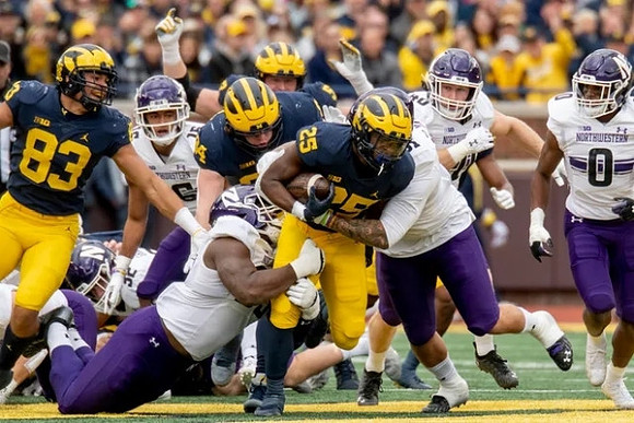 Erick All (83), Joel Honigford (84), Karsen Barnhart (52), and Hassan Haskins (25)