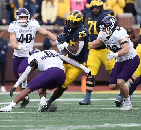 Hassan Haskins (25) and Andrew Stueber (71)