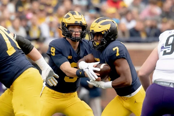 Ryan Hayes (76), J.J. McCarthy (9), and Donovan Edwards (7)