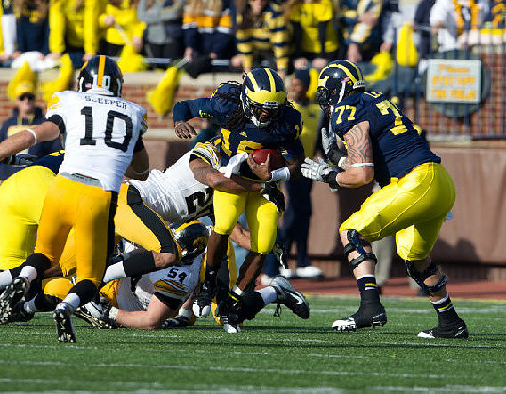 Denard Robinson (16) and Taylor Lewan (77)
