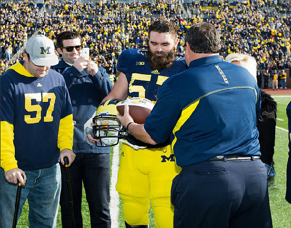 Brock Mealer, Elliott Mealer (57), and Brady Hoke
