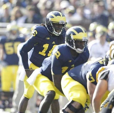 Denard Robinson (16), Devin Gardner (12), and Elliott Mealer (57)