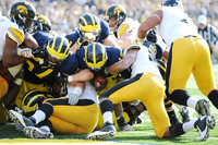 Elliott Mealer (57), Mike Kwiatkowski (81), and Devin Gardner (12)