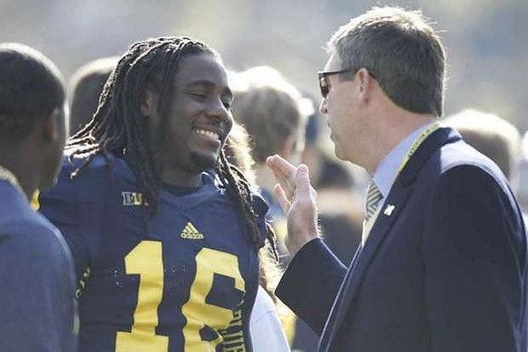 Denard Robinson (16) and David Brandon