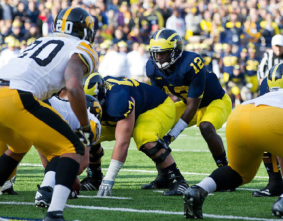Elliott Mealer (57) and Devin Gardner (12)