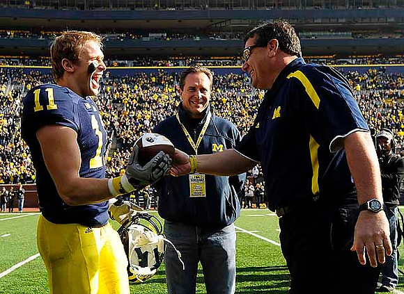 Jordan Kovacs (11) and Brady Hoke