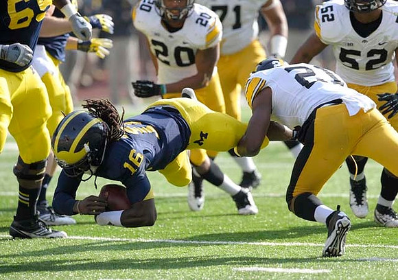 Patrick Omameh (65) and Denard Robinson (16)