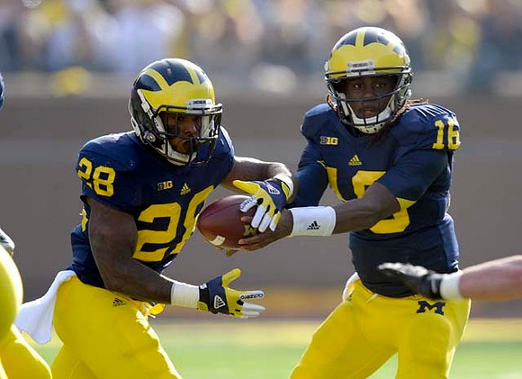 Fitzgerald Toussaint (28) and Denard Robinson (16)