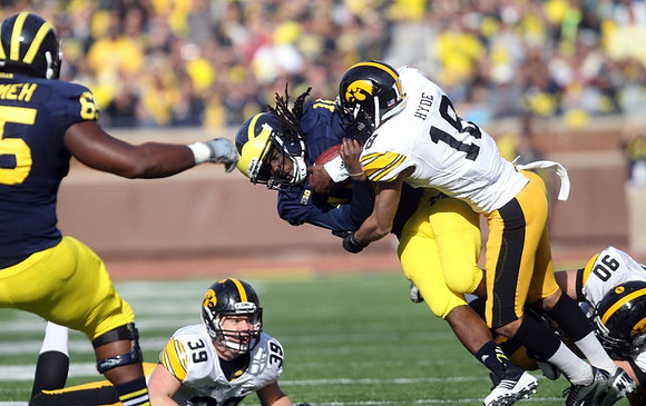 Patrick Omameh (65) and Denard Robinson (16)