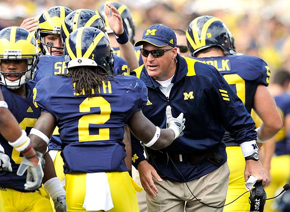 Vincent Smith (2), Rich Rodriguez, and David Molk (50)