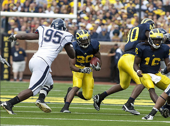 Michael Shaw (20), Martell Webb (80), and Denard Robinson (16)