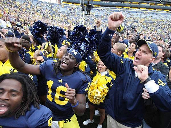 Denard Robinson (16) and Rich Rodriguez