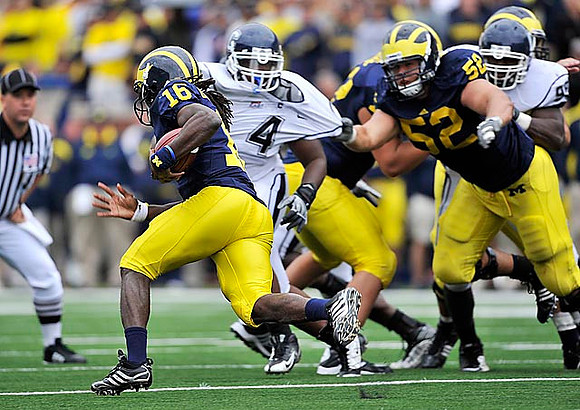 Denard Robinson (16) and Stephen Schilling (52)