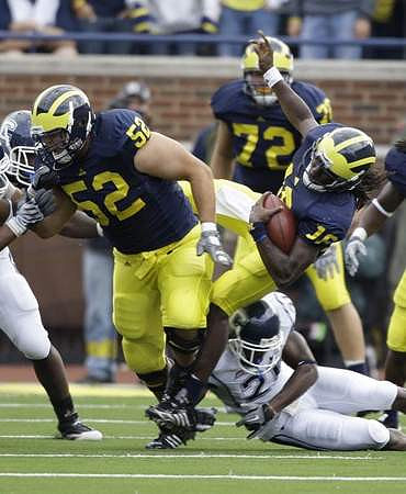 Stephen Schilling (52), Mark Huyge (72), and Denard Robinson (16)