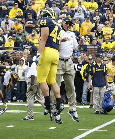 Mark Moundros (44) and Rich Rodriguez