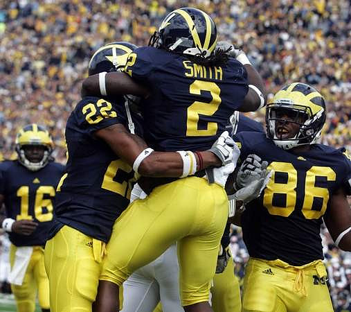 Denard Robinson (16), Darryl Stonum (22), Vincent Smith (2), and Kevin Koger (86)