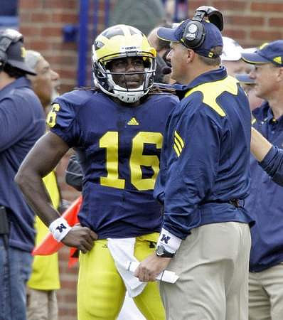 Denard Robinson (16) and Rich Rodriguez