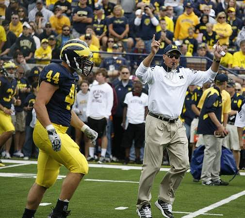 Mark Moundros (44) and Rich Rodriguez