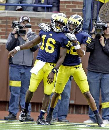 Denard Robinson (16) and Darryl Stonum (22)