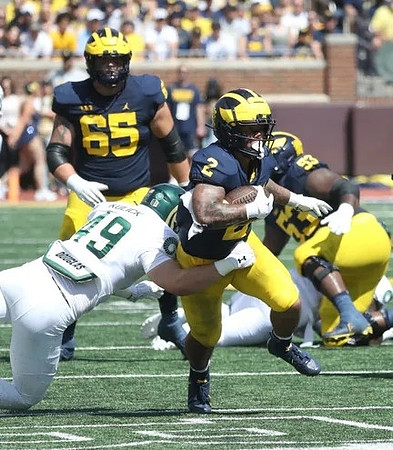 Zak Zinter (65), Blake Corum (2), and Trente Jones (53)