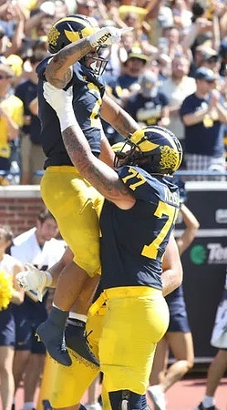 Blake Corum (2) and Trevor Keegan (77)
