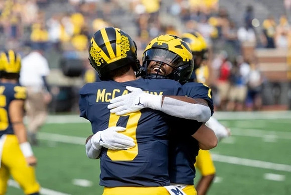 J.J. McCarthy (9) and Donovan Edwards (7)