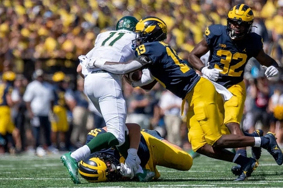 Mason Graham (55), Rod Moore (19), and Jaylen Harrell (32)