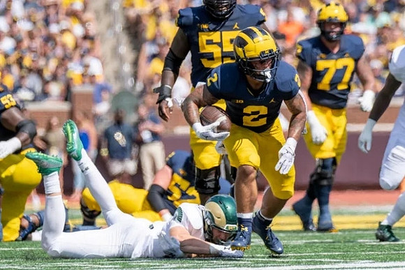 Trente Jones (53), Karsen Barnhart (52), Olusegun Oluwatimi (55), Blake Corum (2), and Trevor Keegan (77)