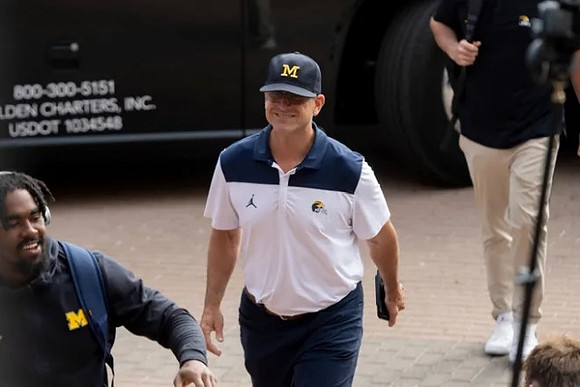 Donovan Edwards (7) and Jim Harbaugh