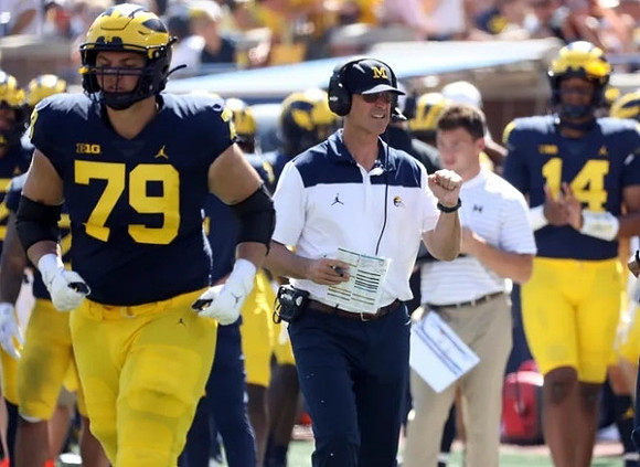 Jeffrey Persi (79), Jim Harbaugh, and Roman Wilson (14)