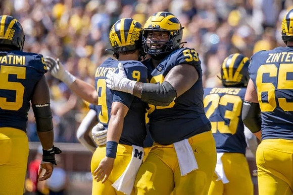 Olusegun Oluwatimi (55), J.J. McCarthy (9), Trente Jones (53), CJ Stokes (23), and Zak Zinter (65)