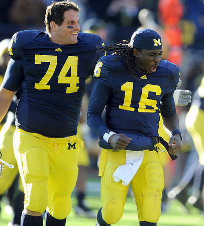 John Ferrara (74) and Denard Robinson (16)