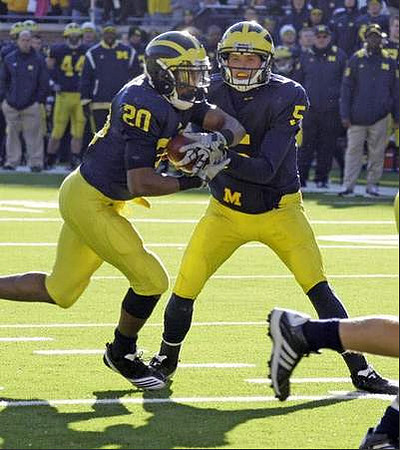 Michael Shaw (20) and Tate Forcier (5)