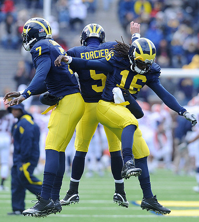 Devin Gardner (7), Tate Forcier (5), and Denard Robinson (16)