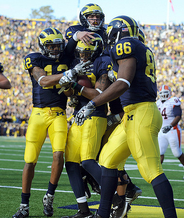 Roy Roundtree (12), Michael Shaw (20), Tate Forcier (5), and Kevin Koger (86)