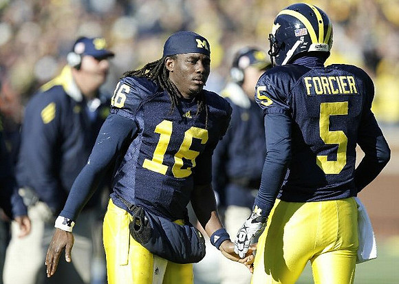 Denard Robinson (16) and Tate Forcier (5)
