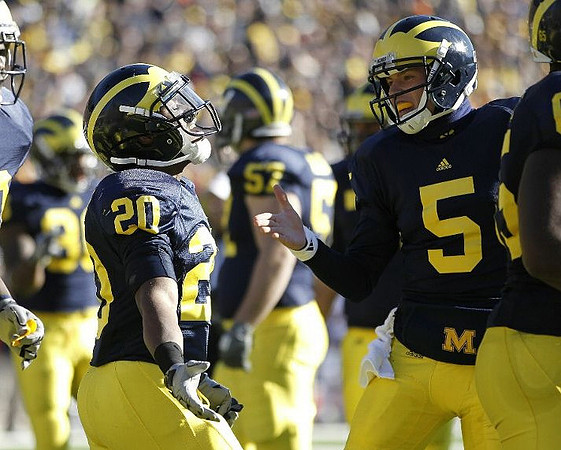 Michael Shaw (20), Tate Forcier (5), and Elliott Mealer (57)