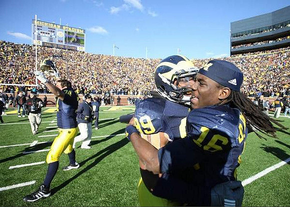 John Ferrara (74), Adam Patterson (99), and Denard Robinson (16)