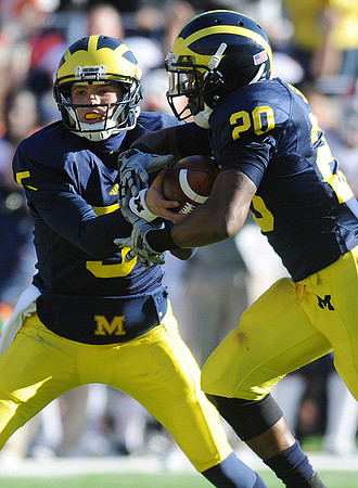 Tate Forcier (5) and Michael Shaw (20)