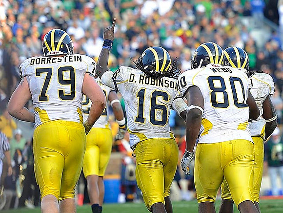 Perry Dorrestein (79), Denard Robinson (16) and Martell Webb (80)