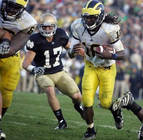 Patrick Omameh (65) and Denard Robinson (16)